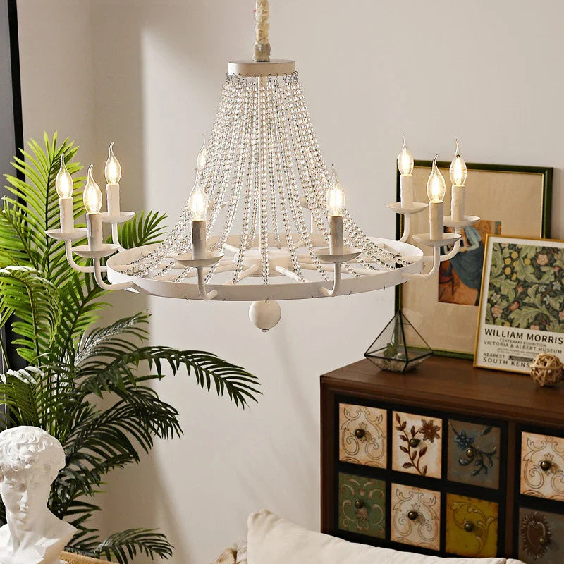 The Maison Ornate Elegant Crystal Chandelier features tassels, gold accents, and intricate crystal detailing.