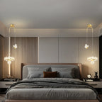 Two Maison Ornate Minimalist Single-Head Crystal Ball Pendant Lights, suspended elegantly. Modern chandelier design focus.