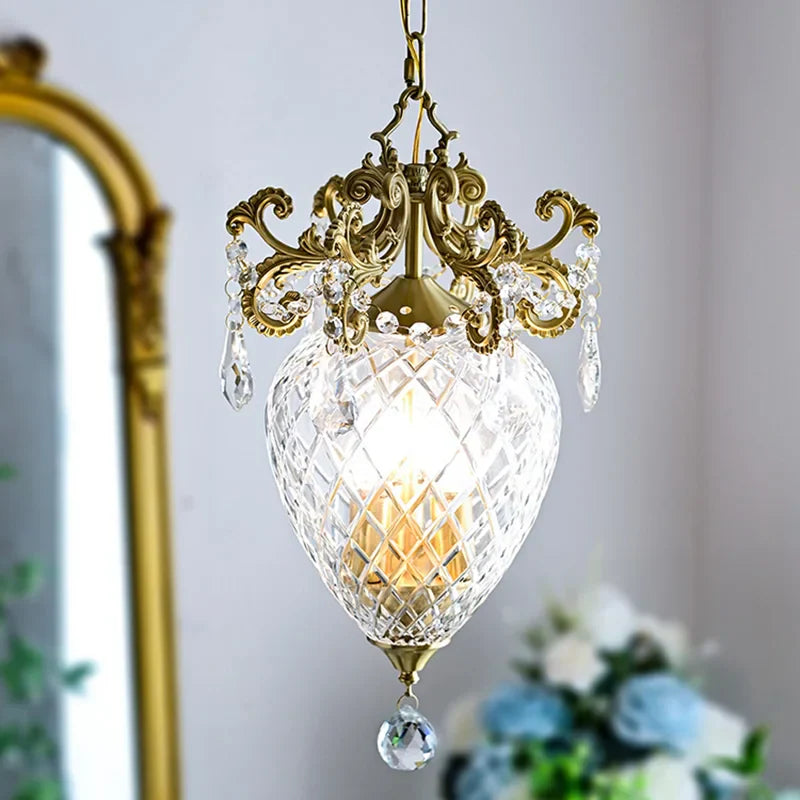 Elegant gold pineapple-style medieval chandelier with ornate crystal accents, glowing warmly, luxurious lighting fixture.