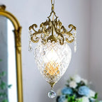Elegant gold pineapple-style medieval chandelier with ornate crystal accents, glowing warmly, luxurious lighting fixture.