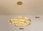 Minimalist Art Deco chandelier with gold-intertwined LED crystal rings suspended by thin wires.