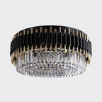 Luxurious circular chandelier with black and gold accents and clear crystal prisms for elegance.