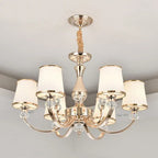 Baroque chandelier with six curved arms, white shades, gold and white finish, sparkling crystals.