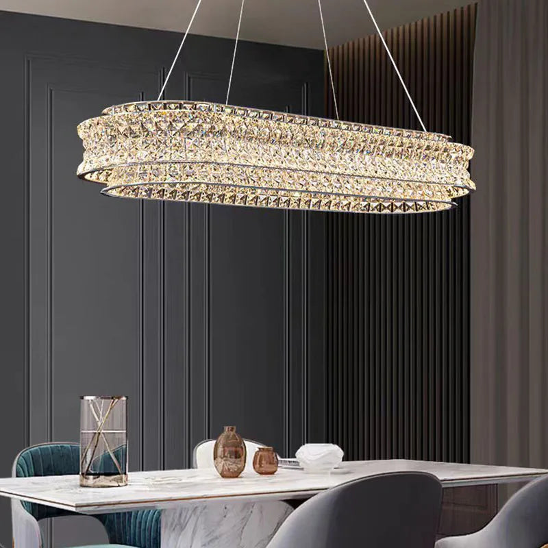Maison Ornate’s Crystal Ball Pendant chandelier with stainless steel adjustable cord, elegantly suspended and illuminated.