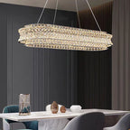 Maison Ornate’s Crystal Ball Pendant chandelier with stainless steel adjustable cord, elegantly suspended and illuminated.