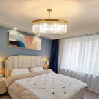 Modern Crystal Chandelier by Maison Ornate, elegant geometric shape, hangs illuminated in the room.
