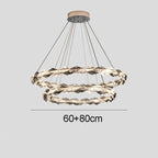 Maison Ornate chandelier with two intertwined LED rings, dimmable function, and sleek metal suspension.