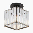 The Crystal Hallway Chandelier has square glass panels, dark metal base, and exposed bulb. Modern industrial look.