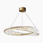 Circular chandelier with twisted crystals, three slim cables, and a round gold mount; elegant sparkle.