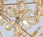 Gold metal chandelier with faceted crystal petals, flower-like design, central bulb, sparkling elegance.