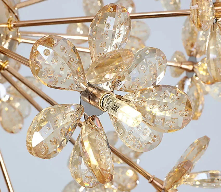 Gold metal chandelier with faceted crystal petals, flower-like design, central bulb, sparkling elegance.