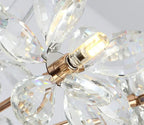 Close-up of Maison Ornate crystal dandelion chandelier with faceted teardrops and lit LED bulb.