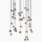 Nordic crystal chandelier with clear glass globes at varied heights for modern elegance.