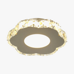 Flower-shaped chandelier with clear faceted crystals and warm LED center, modern and ornate design.