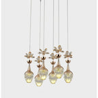 Six Maison crystal pendants with gold accents, clear flower glass shades, varying heights.