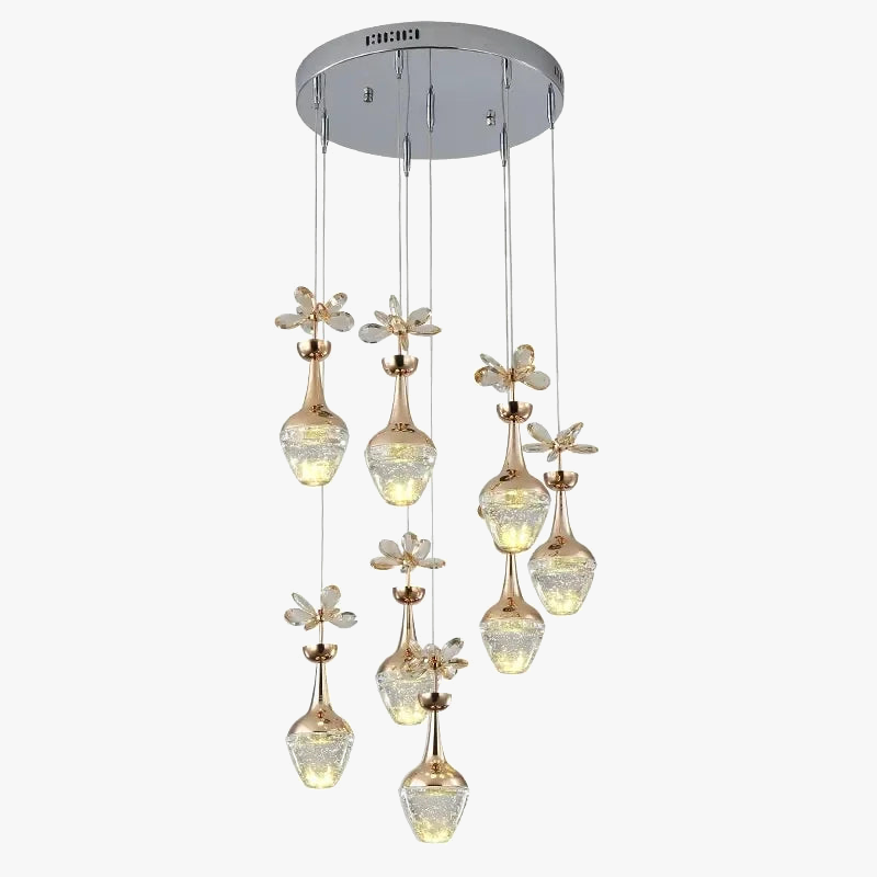 Nine vase-shaped crystal pendant lights with petal accents hang at varied heights from chrome plate.