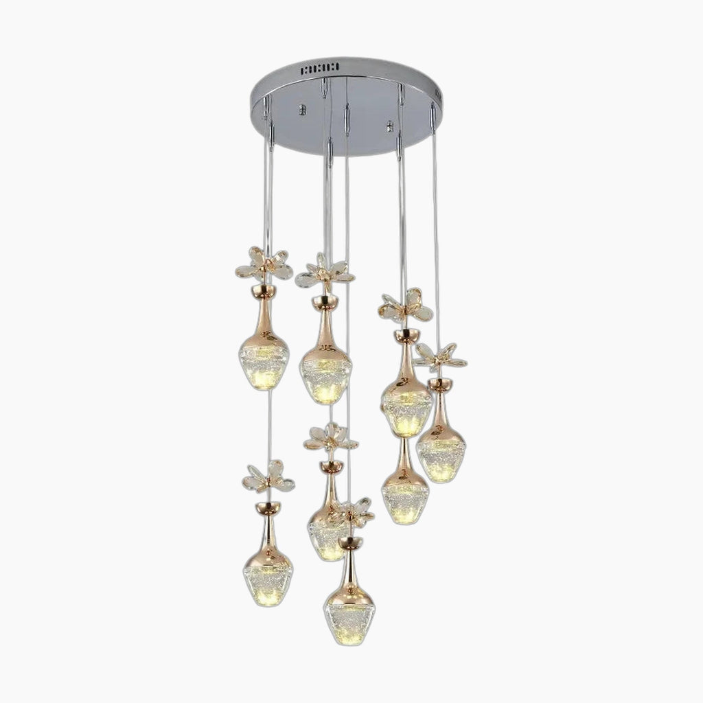 Minimalist crystal chandelier with nine gold and glass flower lights on a chrome round mount.