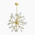 Modern gold chandelier with floral crystal bulbs and starburst branching arms, suspended from matching mount.