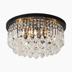 Round flush-mount chandelier with dark base and rows of clear prisms for a sparkling look.
