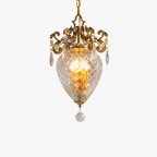 Ornate gold medieval-style chandelier with crystal accents and faceted glass shade for warm light.