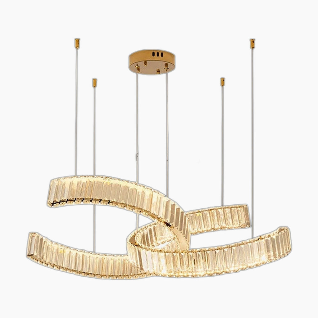 Postmodern chandelier of gold oval rings and crystal segments, suspended by cables from round gold mount.