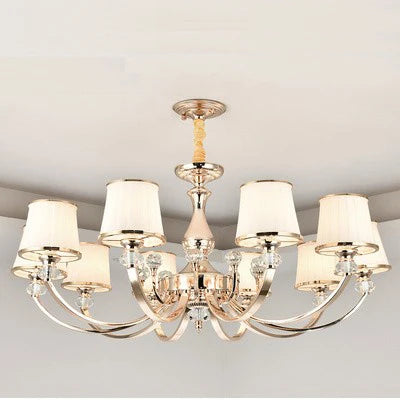 Elegant Baroque chandelier with eight curved arms, cream lampshades, metallic finish, flush mount design.