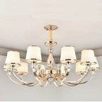 Elegant Baroque chandelier with eight curved arms, cream lampshades, metallic finish, flush mount design.