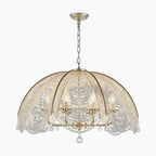 Maison Ornate Nordic chandelier with dome frame, golden and copper finish, crystal beads, four candle-style lights.