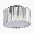 Round LED chandelier with vertical crystal prisms, circular base, and frosted diffuser for modern luxury.