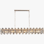 Golden Crystal chandelier with multiple prisms, warm lights, dual chains, rectangular mount—luxurious modern style.
