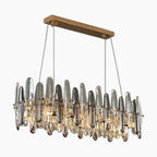 Gold-mounted dimmable chandelier with vertical K9 crystal rods, integrated LED, and four cable suspension.