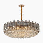 Elegant LED crystal chandelier with gold mount and cord, multi-tiered crystals, emits warm light.