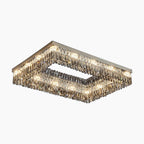 Rectangular LED chandelier with metallic base and cascading crystals, hollow center, modern design.