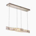 Modern crystal chandelier with metallic base, wavy LED design, and four suspension cords.