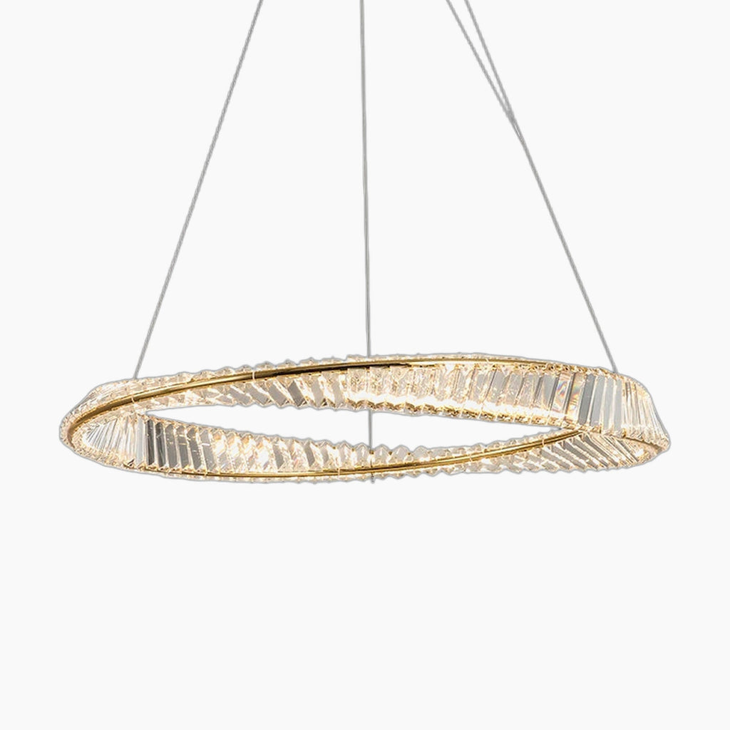 Faceted crystal ring chandelier in gold, suspended by thin wires, emits warm contemporary glow.
