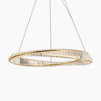 Faceted crystal ring chandelier in gold, suspended by thin wires, emits warm contemporary glow.