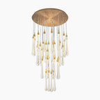 Round gold LED chandelier with teardrop glass droplets, gold accents, and adjustable hanging height.