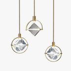 Luxurious postmodern Nordic chandelier with three brass-framed geometric glass pendants on thin rods.