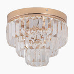 Round gold-base LED chandelier with tiered clear K9 crystal prisms, elegant and decorative.