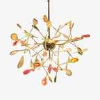 Contemporary flower-shaped chandelier with gold branches, vibrant crystal accents, and exposed LED bulbs.