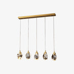 Gold-based chandelier with five faceted crystal bulbs and teardrop accents, elegantly suspended.