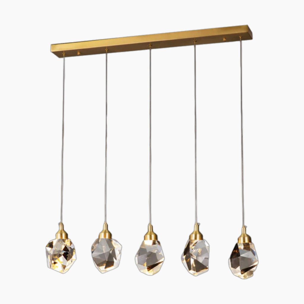 Five gold fixtures with geometric crystal pendants hang from a rectangular gold chandelier mount.