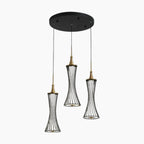 Modern LED crystal chandelier with three gold and black wire cage pendants hanging at varied heights.