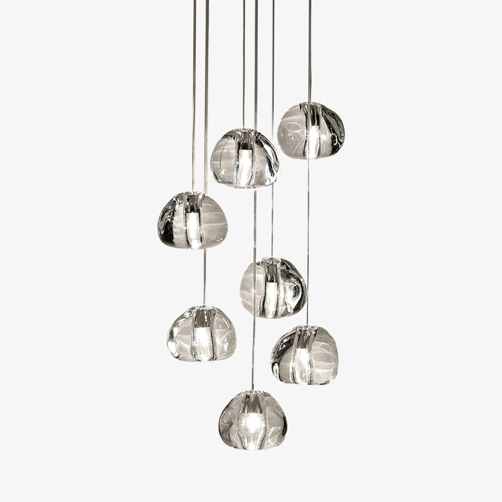 Eight clear, irregular glass pendants hang at varying lengths for a modern icicle chandelier.