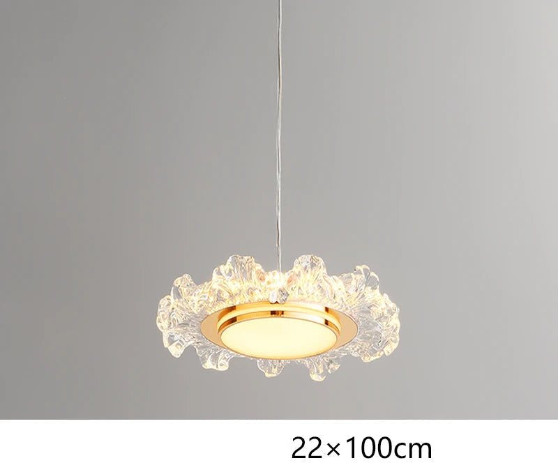 Modern crystal chandelier with circular gold frame, wavy edges, and LED lighting, suspended by thin cord.