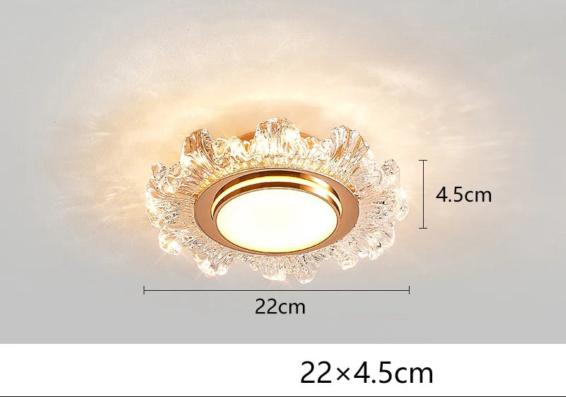 Round gold and clear glass modern chandelier with warm LED light; 22 cm diameter, 4.5 cm height.