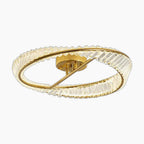The chandelier has a gold circular frame, textured crystal glass edge, and a diagonal gold bar.