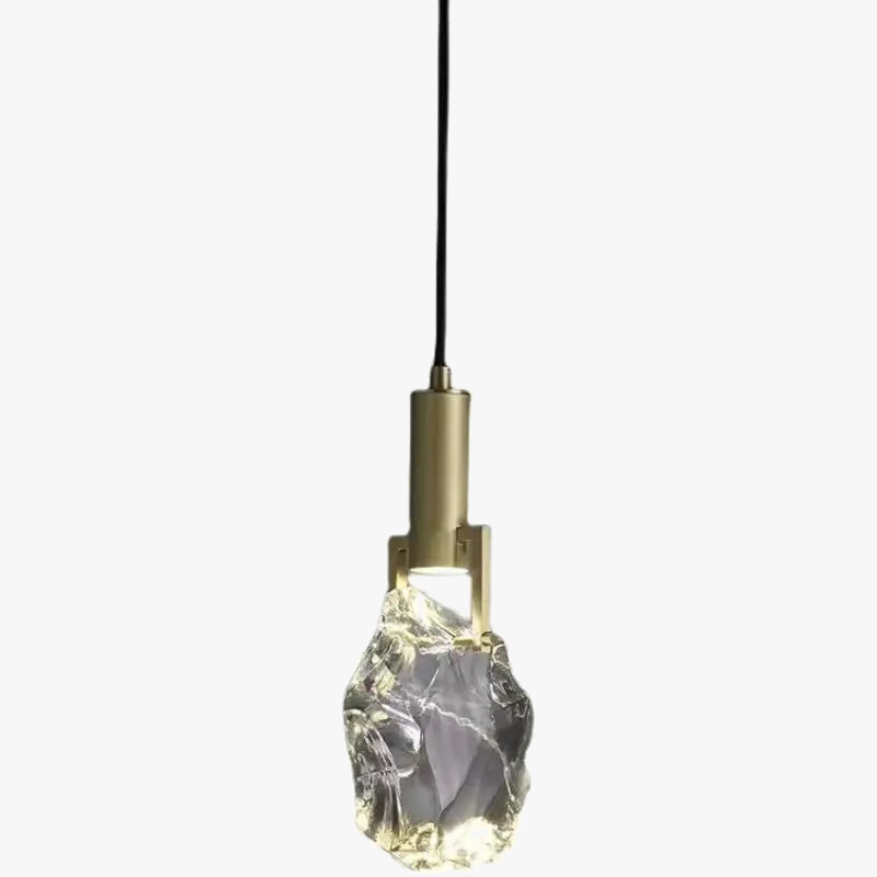 Modern minimalist gold chandelier with irregular crystal glass shade and black cord suspension.