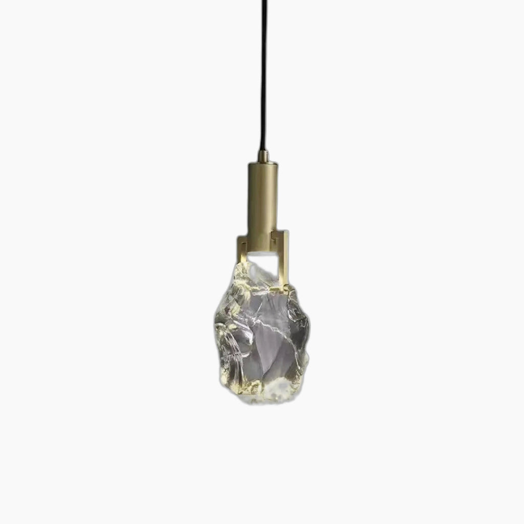 Modern copper chandelier with crystal-like glass shade, suspended by black cord; minimalist, elegant design.