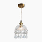 Brass and crystal Nordic chandelier with clear glass shade, twisted cord, and elegant crystal accents.
